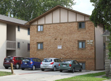 apartment building with parking lot